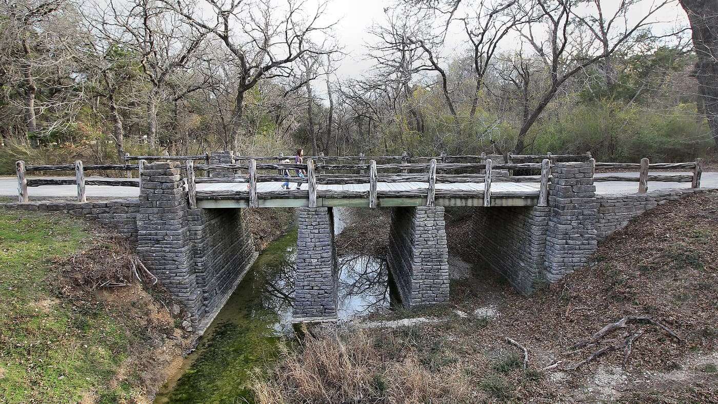 Civilian Conservation Corps Company 3804 developed features like Camp Creek Bridge in Cleburne State Park in Johnson County, Texas between 1935 and 1940.